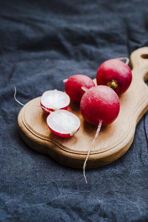 Red radish on black textile background, close-upの写真素材