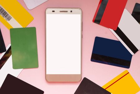 Credit and discount cards are located next to the phone. Place for text. Mock upの写真素材