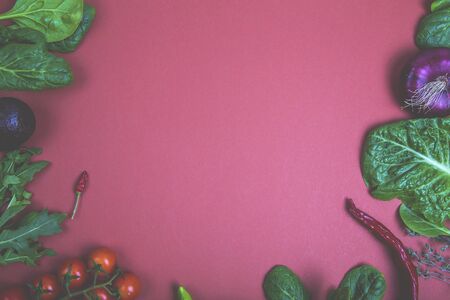 Raw organic vegetables with fresh ingredients for healthily cooking on black background, top view. Vegan or diet food concept. Background layout with free text spaceの写真素材