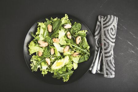 Healthy fresh salad with mussels, avocado, lettuce, spinach and arugula . Top view. Diet conceptionの写真素材