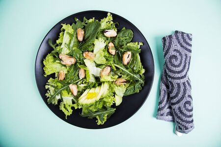 Healthy fresh salad with mussels, avocado, lettuce, spinach and arugula. Top view. Diet conceptionの写真素材