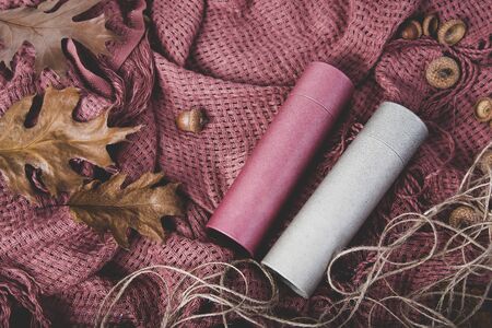 Aumn composition. Dried leaves, acorn and papper round box on the plaid. Autumn, fall concept. Top veiw, copy spaceの写真素材