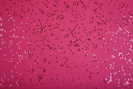 Glittering stars on red background. Festive holiday backdropの写真素材