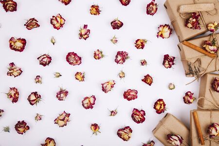 Dry roses and gift box on a white background. Flat lay, top viewの写真素材