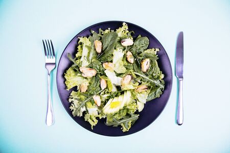 Healthy fresh salad with mussels, avocado, lettuce, spinach and arugula. Top view. Diet conceptionの写真素材