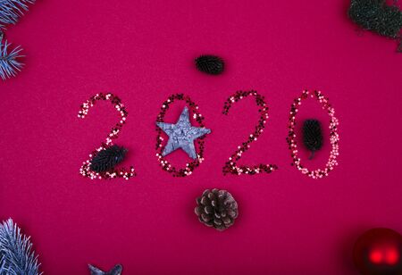 Christmas, New Year composition. Glittered number 2020, Christmas bauble and fir branches on black background. Flat lay, top view.の写真素材