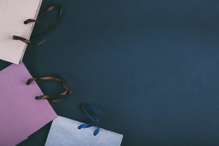 Black Friday shopping sale concept. Paper bags on dark blue background. Flat lay