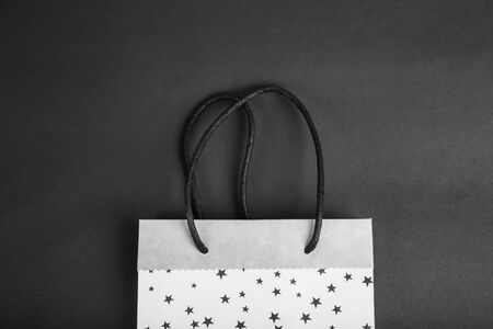 Black Friday shopping sale concept. Paper bag. Black monochromatic image.の写真素材