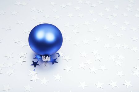 Holiday background with little silver stars with Christmas ball on silver background. Festive holiday backdrop.の写真素材