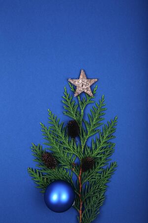 Christmas decoration balls with fir cones and fir branch on a blue backgroundの写真素材