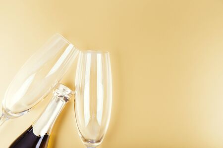 Pair glass of champagne with bottle. New Year celebration theme with blur spots of bubblesの写真素材