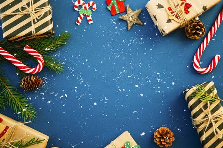 Christmas or New Year blue background, Xmas black board framed with season decorations, space for a text, view from above.の写真素材
