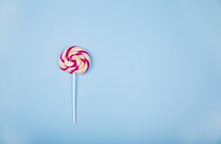 Colorful lollipop on light blue background. Food conceptの写真素材