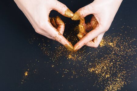 Female hand showing heart shape gesture. Fastive background, space for textの写真素材