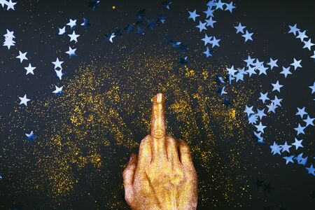 Hand shows aggressive gesture with the middle finger. Fuck you Christmas and New Year concept. Minimal style.の写真素材