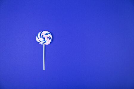 Colorful lollipop on light blue background. Food conceptの写真素材