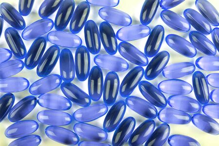Omega 3. Fish oil capsules on white background and texture, vitamin D supplement. Close up, high resolution product. Health care conceptの写真素材