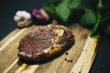Fresh raw Prime Black Angus beef steaks on wooden board: Tenderloin, Denver Cut, Striploin, Rib Eyeの写真素材