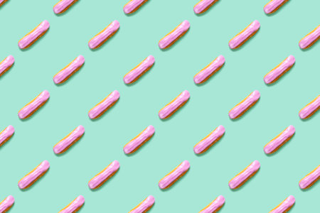 Flat lay with arranged homemade eclairs pattern with blackberries and blueberries on mint color backgroundの写真素材