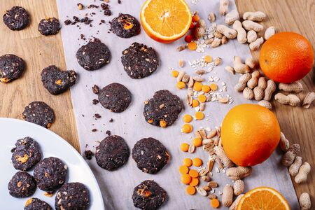 Handmade chocolate cookies with orange and cinnamon and nuts. Candies, chocolate, citrus, cinnamon. Top viewの写真素材