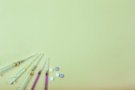 Medicines pills and syringes on color background. Healthcare, coronavirus concept