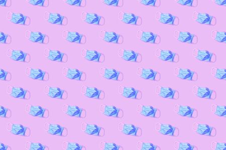 Medical mask pattern on pink background. Protective face mask backgroundの写真素材