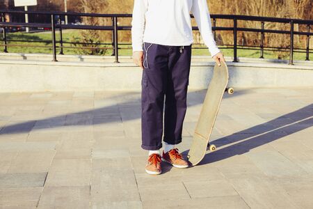 Boy standing with skateboard. Skateboarding Practice Freestyle Extreme Sports Conceptの写真素材