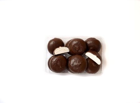 marshmallows in chocolate, sweets on a background with a mug of coffeeの写真素材