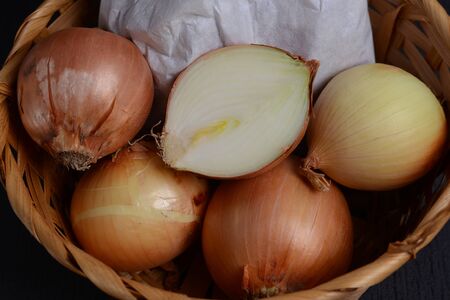 chopped onions with a knife on a cutting board on a black backgroundの写真素材