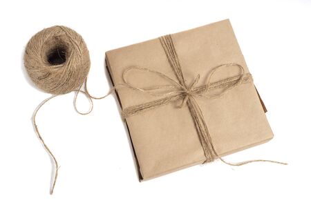 wrapped in kraft paper and tied with a ribbon isolated on white backgroundの写真素材