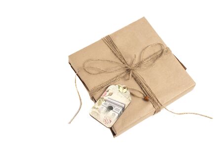 wrapped in kraft paper and tied with a ribbon isolated on white backgroundの写真素材