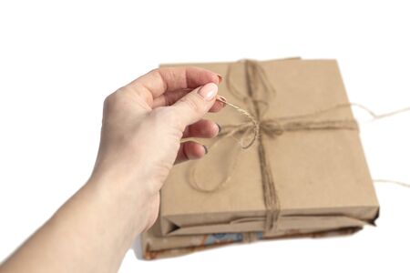 wrapped in kraft paper and tied with a ribbon isolated on white backgroundの写真素材