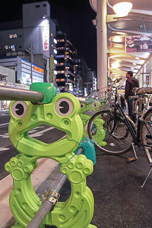 Kyoto Downtown, Japan - 2010: Cute frog shape railing to lock bicycles along sidewalkのeditorial素材
