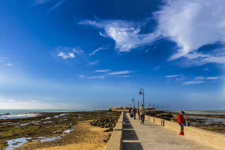 Cadiz, Spain - Dec, 2018: Paseo Fernando Quinones stone pathway leading to Castillo de San Sebastianのeditorial素材
