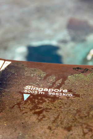 Little signage on Table Mountain showing distance to Singapore
