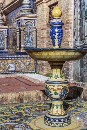 Seville, Spain - Dec 2018: A ceramic titled fountain ornate at a alcove at Spain Squareのeditorial素材