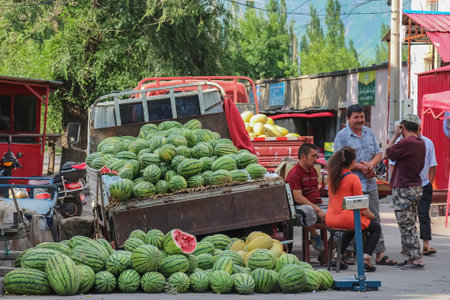 Yining, Xinjiang, China - 13th July 2014: A truckload of watermelons on sale by the street cornerのeditorial素材
