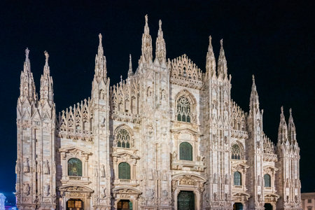 The front facade of Milan Cathedral taken at nightの写真素材