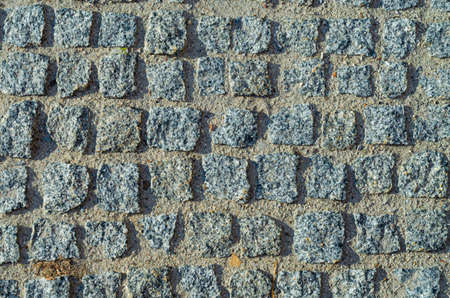 Texture of rectangular granite paving stone with sand. Pattern of pavement.の写真素材