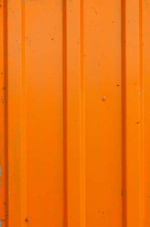 Corrugated orange matt metal sheet texture. Monochrome stripe background.の写真素材