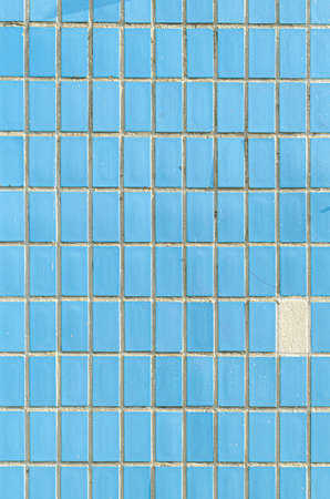 Little blue ceramic square tiles texture. The wall is casually lined with rectangular small tiles.の写真素材
