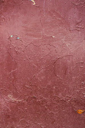 Dark red painted metal texture. Texture of rough surface of old wall with a cracks, patterns and stainsの写真素材