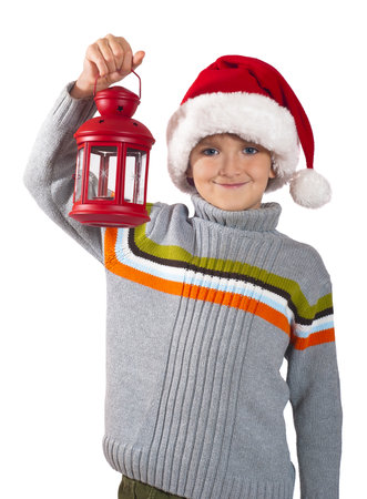 Smiling kid in red cap with Christmas lanternの写真素材
