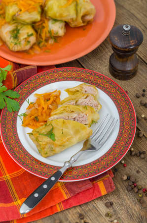 Delicious stuffed cabbage slices on a plate with fork. Freshly prepared food on the dining table ready to eat. Large portion of food for energy.の写真素材
