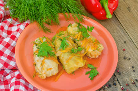 Three delicious stuffed cabbage on a plate. Freshly prepared food on the dining table ready to eat. Large portion of food for energy.の写真素材