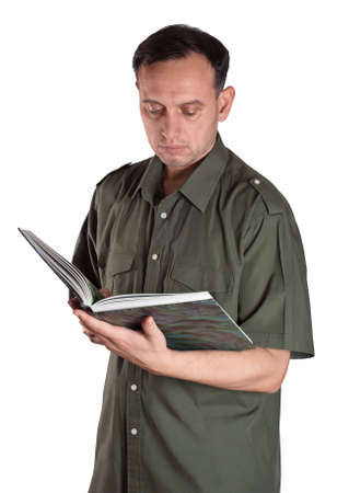 Confident man in green shirt carefully reading a big green book. Studio shot of a serious man posing for the camera. Unique male emotions with different poses and objects.の写真素材