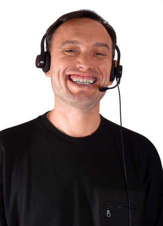 Confident man in black clothes listen to a signal in headset and laughing loud. Studio shot of a serious man posing for the camera. Unique male emotions with different poses and objects.の写真素材