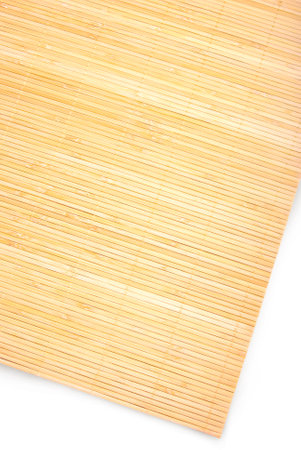Light bamboo carpet with beige sticks and threads. Woven for tabletop grace, the rug adds a touch of warmth and texture, inviting a serene dining experience.の写真素材