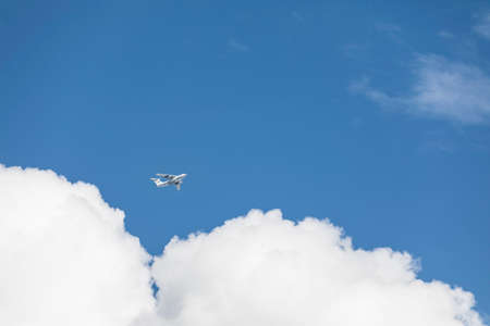 Flying plane in a clear skyの写真素材