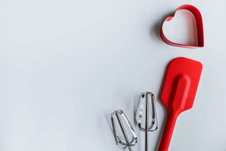 Baking supplies on white. Spatula, mixer whisks, cookie cutter on white backgroundの写真素材